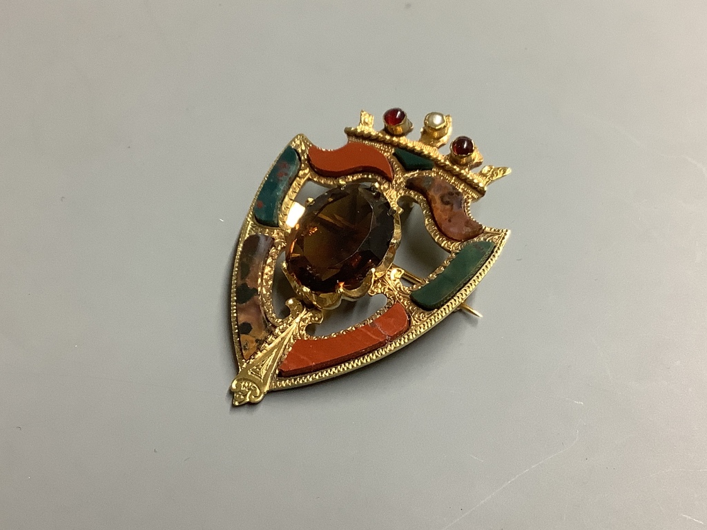 A late Victorian 15 carat gold citrine, seed pearl, cabochon and Scottish hardstone set shield brooch, 46 mm, gross 9.9 g.